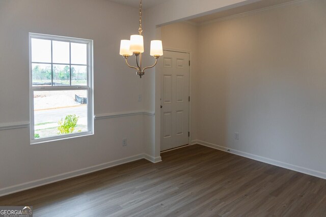 89 Hampton Ridge Way, Jefferson, GA 30549 - unfurnished dining area featuring a chandelier, dark wood-style floors, baseboards, healthy amount of natural light, and ornamental molding
