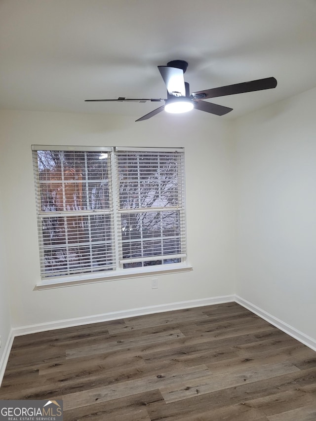 spare room featuring ceiling fan and dark hardwood / wood-style flooring