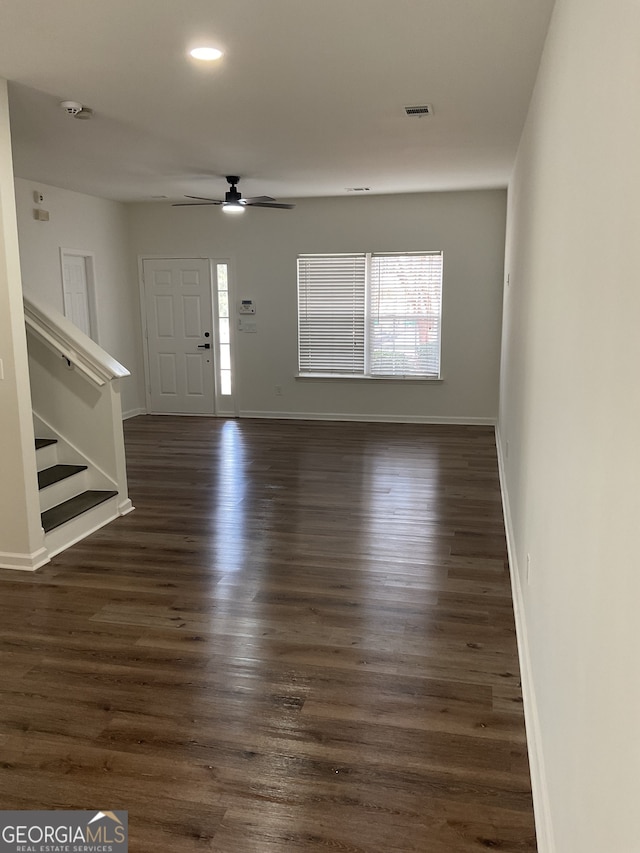 foyer featuring ceiling fan, dark hardwood / wood-style flooring, and a healthy amount of sunlight