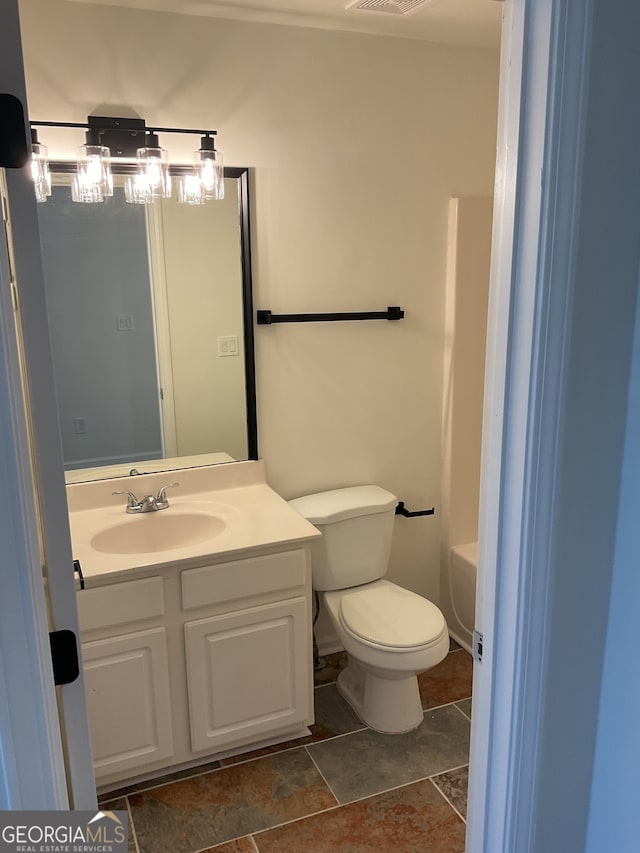 bathroom featuring vanity and toilet