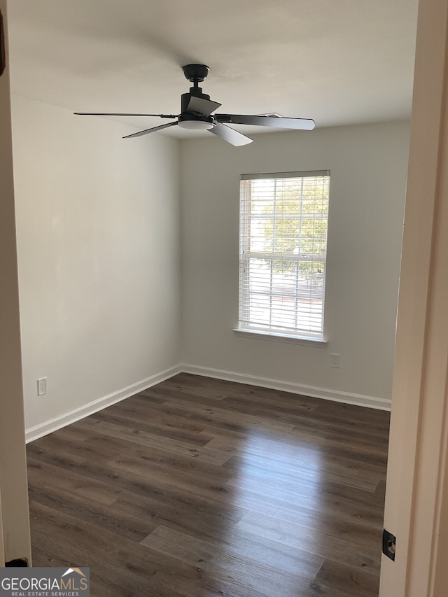 spare room featuring ceiling fan and dark hardwood / wood-style floors