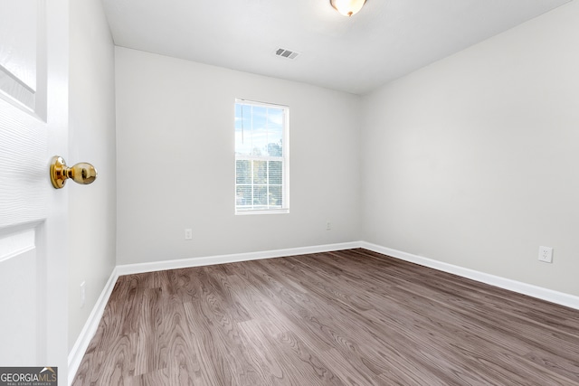 spare room with hardwood / wood-style floors