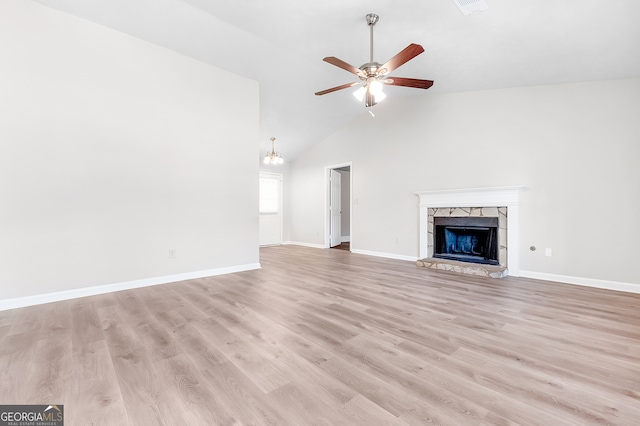 unfurnished living room with light hardwood / wood-style floors, ceiling fan, and high vaulted ceiling