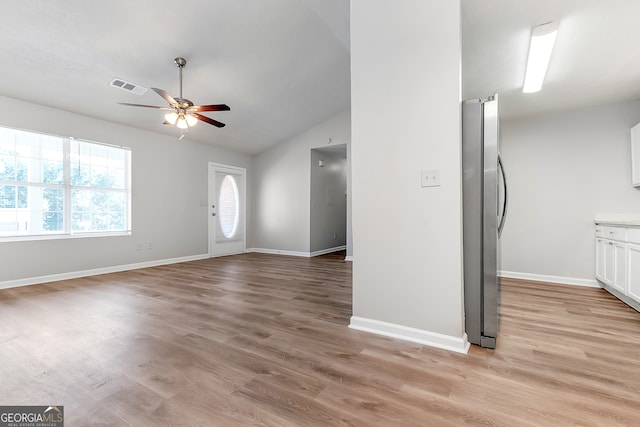 interior space featuring light wood-type flooring, ceiling fan, and vaulted ceiling