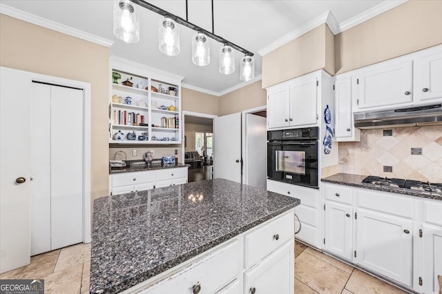 kitchen with white cabinetry, ornamental molding, dark stone counters, and oven