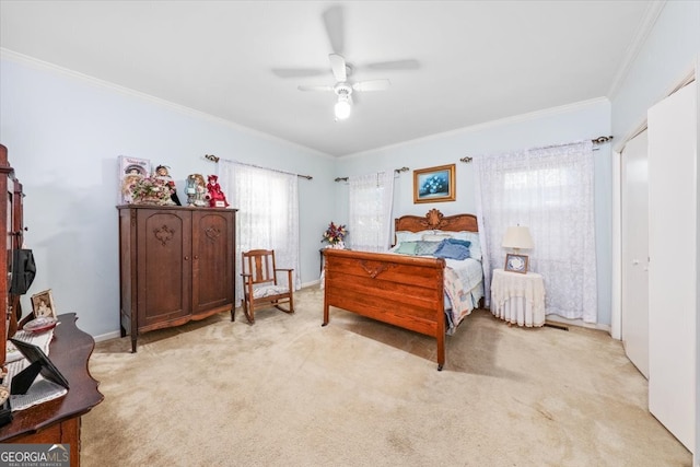 carpeted bedroom featuring ornamental molding and ceiling fan