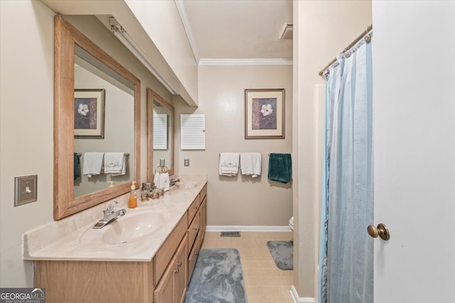 bathroom with vanity, toilet, and ornamental molding