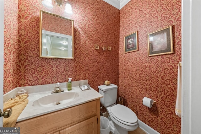 bathroom featuring ornamental molding, vanity, and toilet