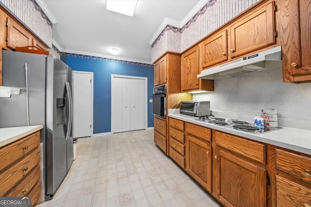 kitchen with white gas stovetop, oven, stainless steel fridge, and crown molding