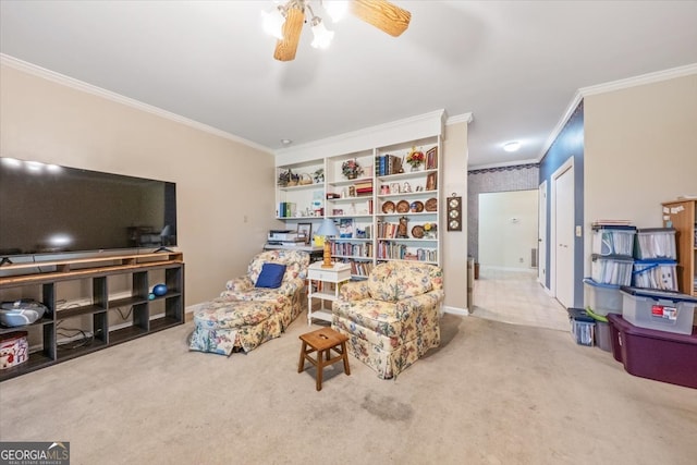 living room featuring ceiling fan, ornamental molding, and carpet floors