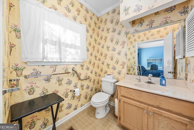 bathroom featuring toilet, vanity, and crown molding