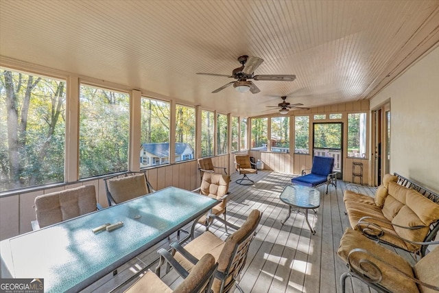 sunroom / solarium featuring ceiling fan