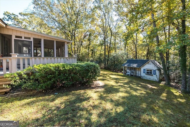 view of yard with an outbuilding and a sunroom