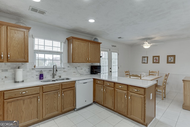 kitchen featuring sink, kitchen peninsula, ornamental molding, white dishwasher, and ceiling fan