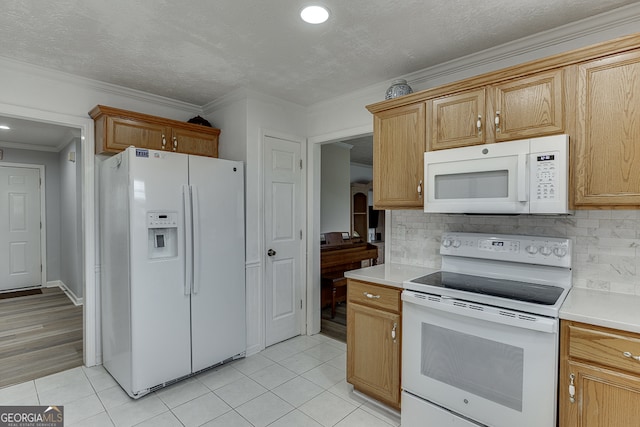 kitchen with white appliances, backsplash, light tile patterned flooring, and ornamental molding