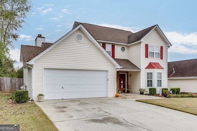 view of front property featuring a garage and a front yard