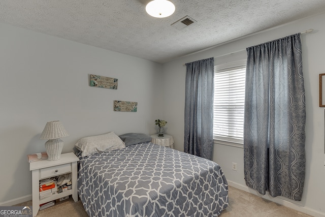 carpeted bedroom with a textured ceiling