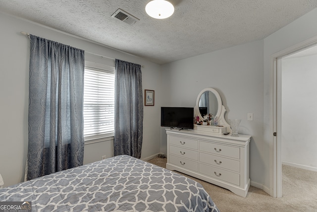 carpeted bedroom featuring a textured ceiling