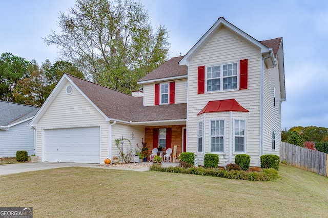 front of property with covered porch, a garage, and a front lawn