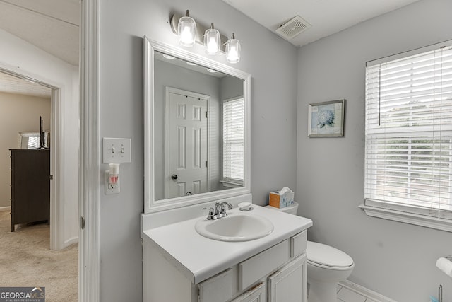 bathroom featuring vanity and toilet