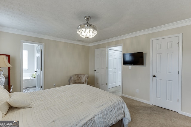 carpeted bedroom with ensuite bathroom, a textured ceiling, and ornamental molding