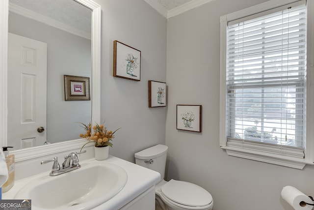 bathroom with vanity, toilet, a textured ceiling, and crown molding