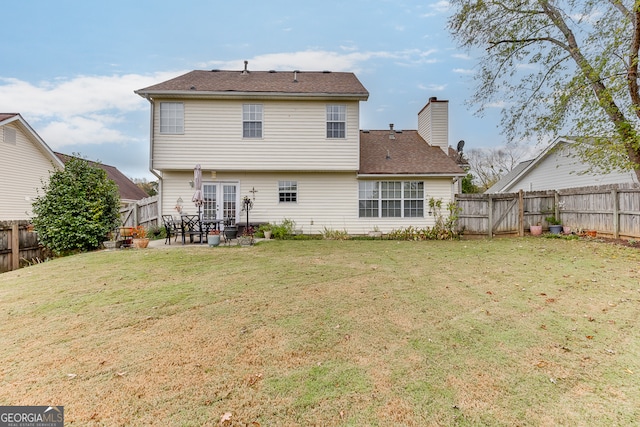 back of house with a patio and a yard