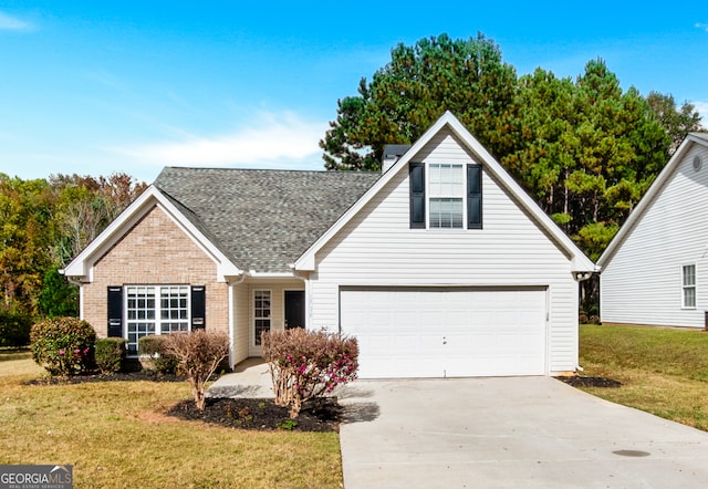 view of front of house with a garage and a front lawn