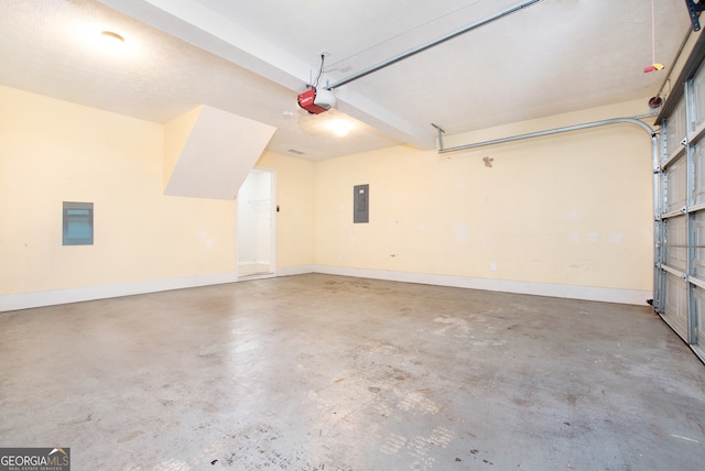 garage with a garage door opener and electric panel