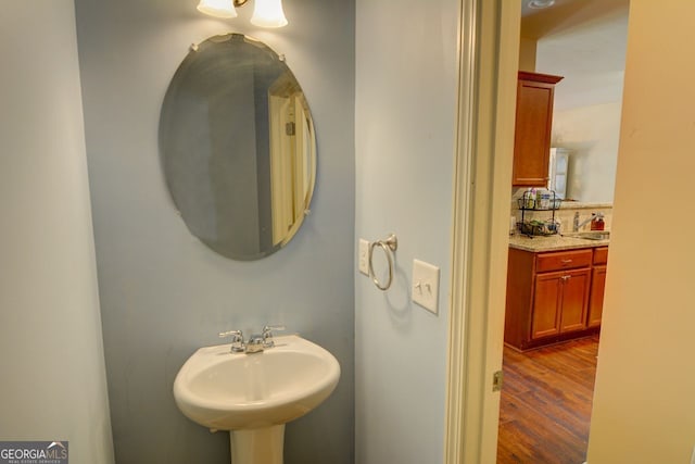 bathroom with hardwood / wood-style floors and sink