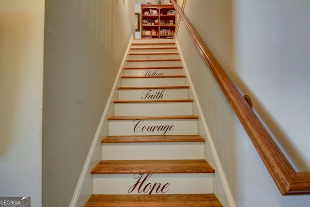 stairway featuring wood-type flooring