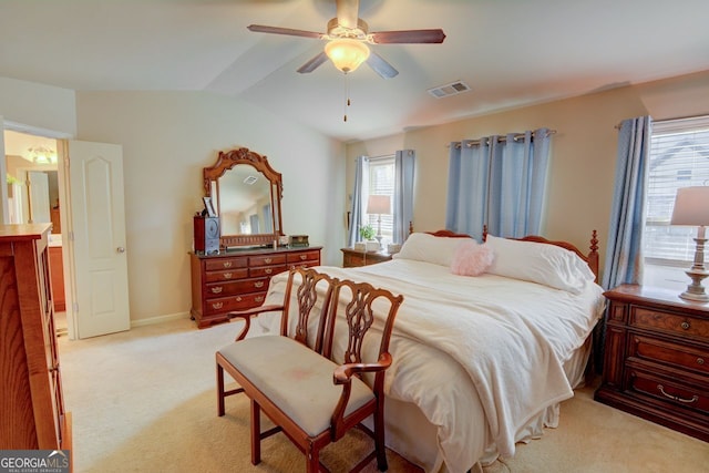 carpeted bedroom with vaulted ceiling and ceiling fan