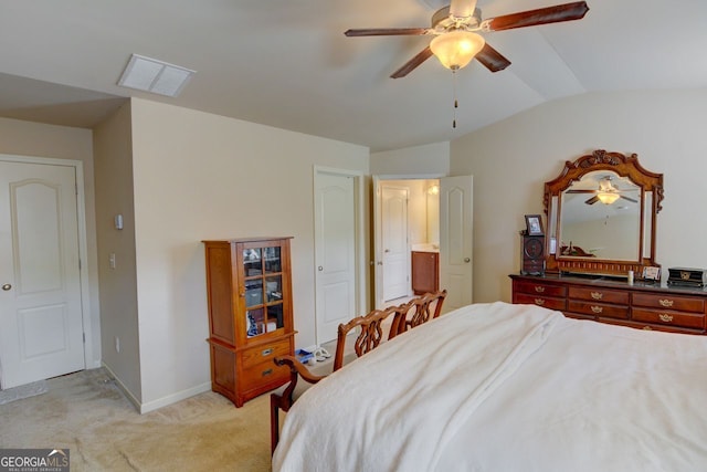 carpeted bedroom with ceiling fan and vaulted ceiling