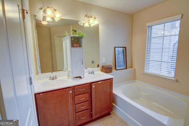 bathroom with a tub, tile patterned flooring, vanity, and an inviting chandelier