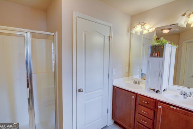 bathroom with vanity and a shower with door