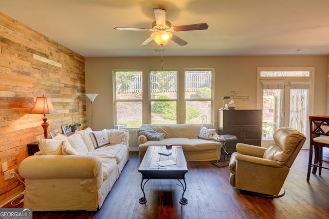 living room featuring ceiling fan and dark hardwood / wood-style flooring