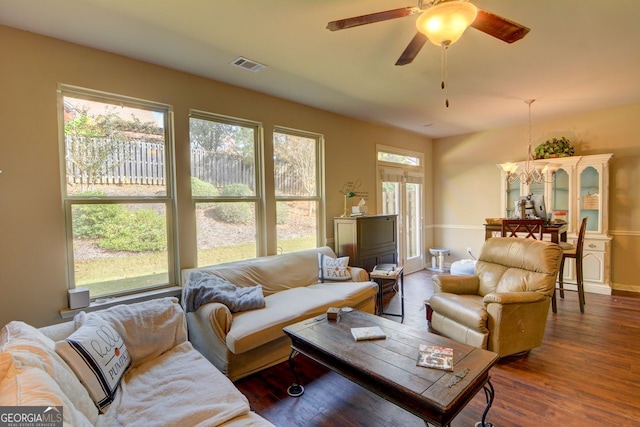 living room featuring ceiling fan and dark hardwood / wood-style flooring