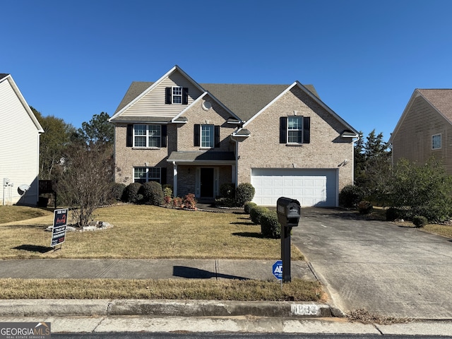 view of front property featuring a front yard and a garage