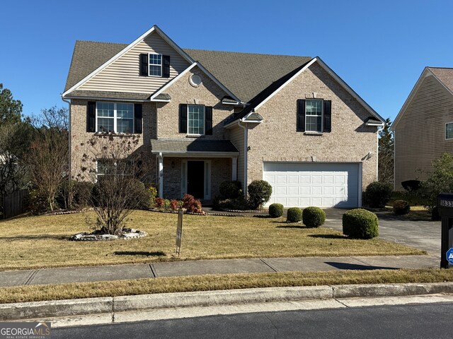 front of property with a front yard and a garage