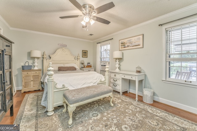 bedroom with baseboards, a ceiling fan, ornamental molding, wood finished floors, and a textured ceiling