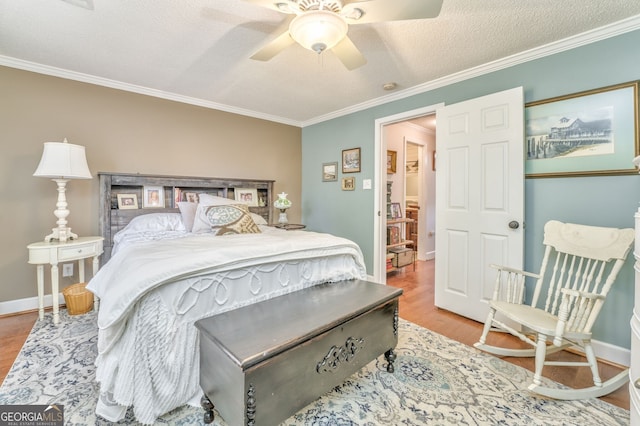 bedroom with ornamental molding and wood finished floors