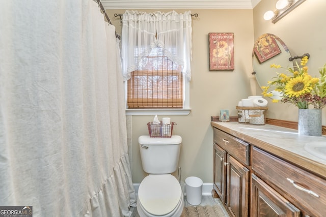 bathroom featuring crown molding, toilet, vanity, a shower with curtain, and baseboards