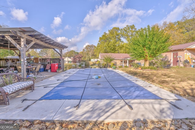 view of pool featuring fence, a pergola, and a patio