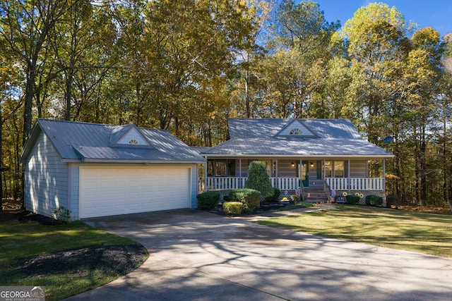 view of front facade with a garage, a porch, and a front lawn