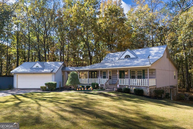 view of front facade with covered porch, a garage, and a front lawn