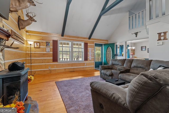 living room featuring high vaulted ceiling, beamed ceiling, wooden walls, and wood-type flooring