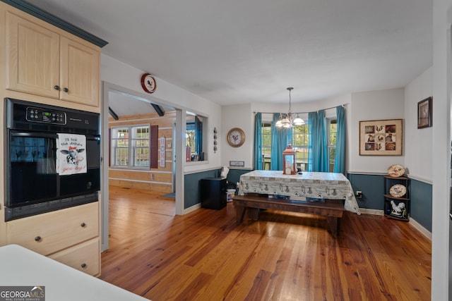 interior space with wood-type flooring and an inviting chandelier