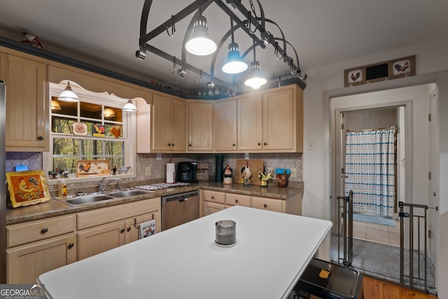 kitchen featuring dishwasher, decorative backsplash, sink, and hardwood / wood-style flooring