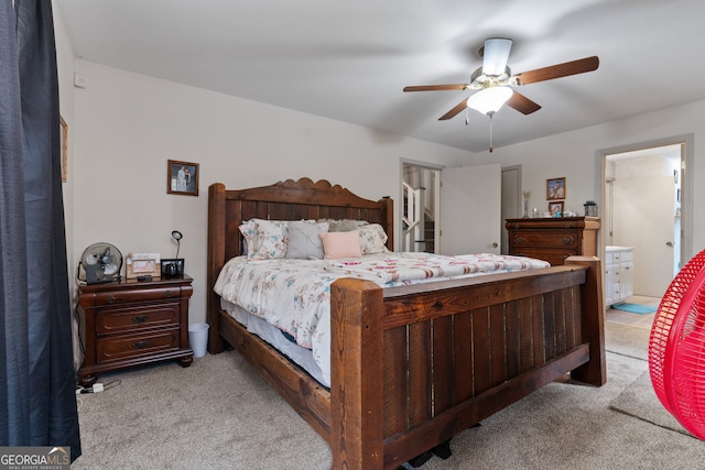 carpeted bedroom with ceiling fan and connected bathroom