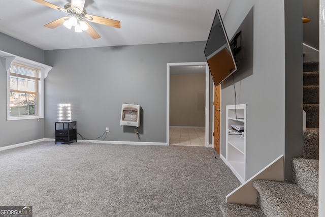 unfurnished room featuring carpet flooring, ceiling fan, and heating unit